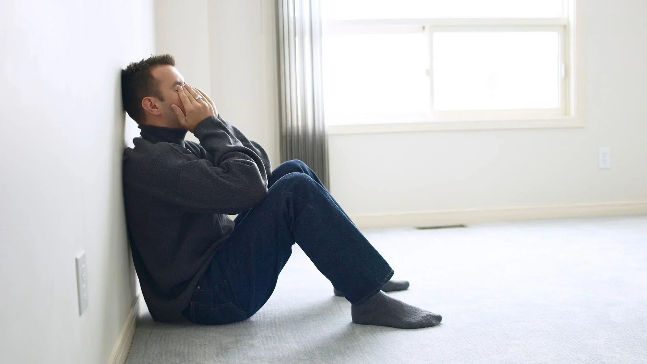 Image of Emotionally Exhausted Man Sitting on Floor