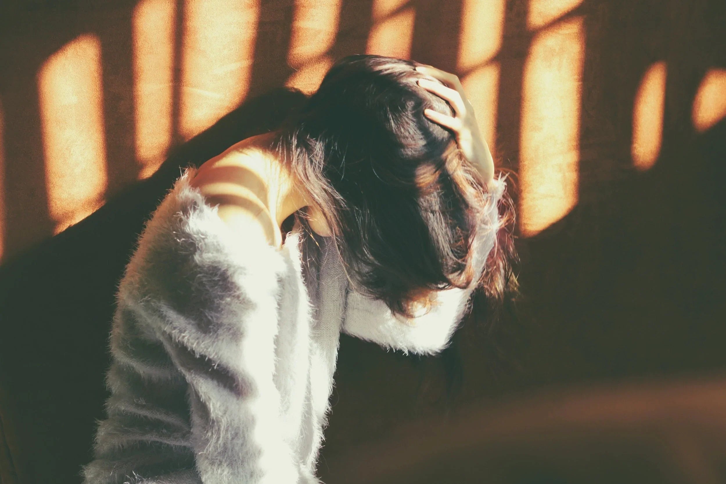 Image of Woman Holding Her Head